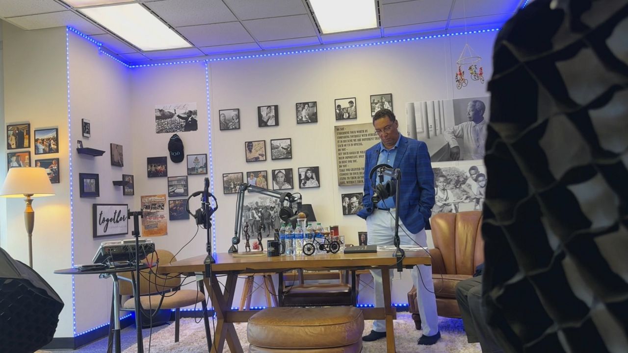 Garrett Davis looks at images of the civil rights movement in his studio space.